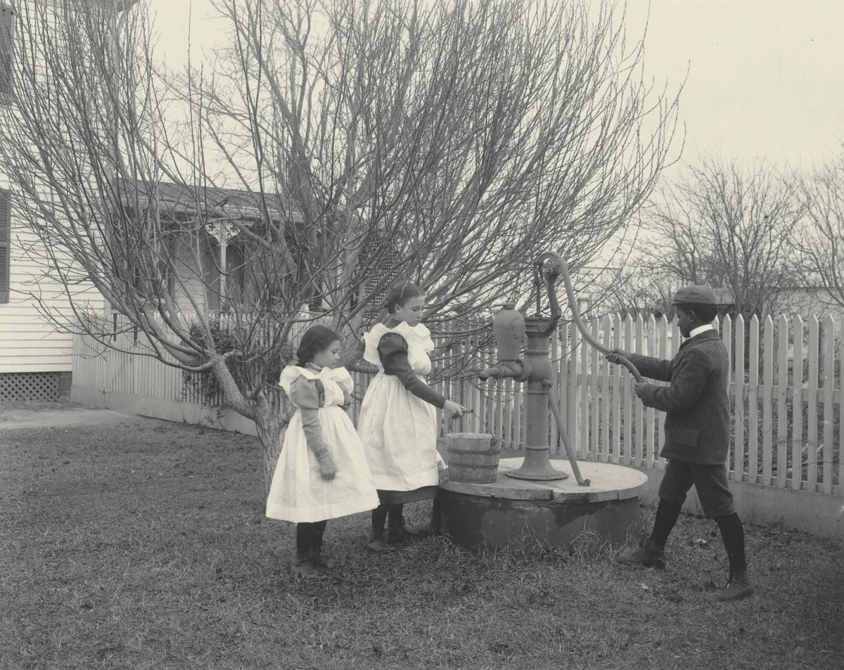 The improved well. (Three Hampton grandchildren.) by Frances Benjamin Johnston, photograph, 1899