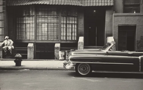 On his day off Mel sometimes puts on his best clothes and comes to the street as a visitor. by Robert Frank, photograph, 1951