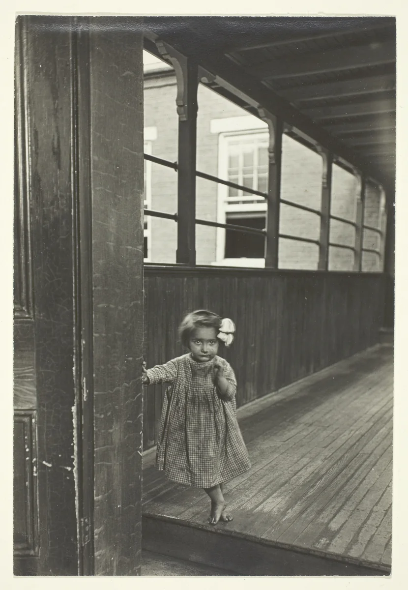 Little Girl Standing At Entrance To A Gallery by Lewis Wickes Hine, photograph, 1909