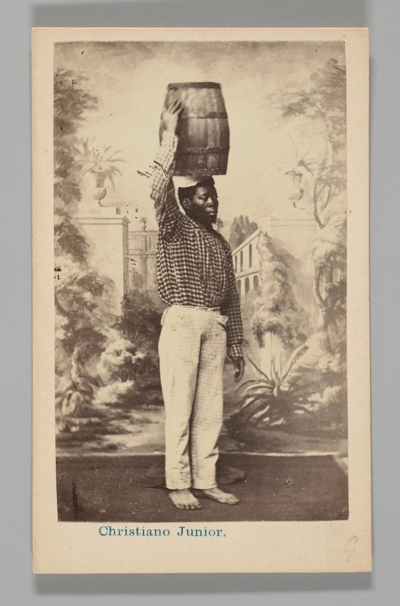 [Studio Portrait: Male Street Vendor with Barrel on Head, Brazil] by Christiano Junior, photograph, 1864-1866