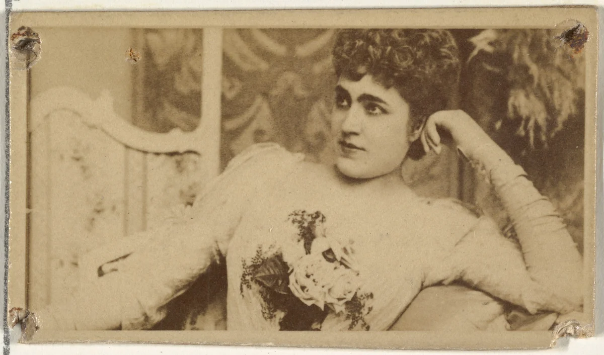[Actress lounging while holding bouquet of flowers], from the Actors and Actresses series (N145-8) issued by Duke Sons & Co. to promote Duke Cigarettes by W. Duke, Sons & Co., photograph, 1890-1895