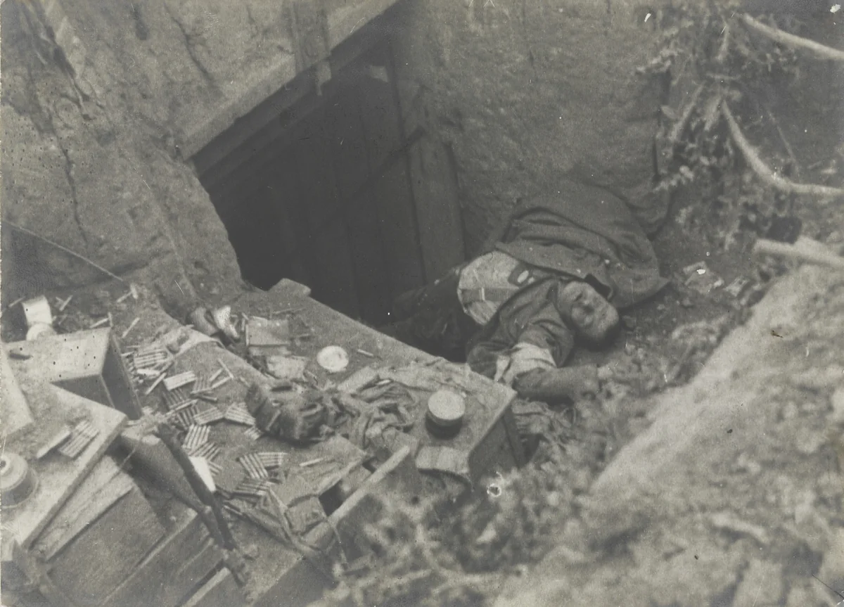 German Soldier Killed Near his Machine Gun at the Entrance to His Dugout on the Western Front by Ministere De La Guerre, photograph, 1916