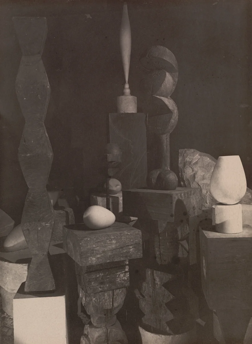 Untitled (View of the Studio with Endless Column, Beginning of the World, Adam and Eve, Bird in Space, and Torso of a Young Girl) by Constantin Brâncuși, photograph, 1922