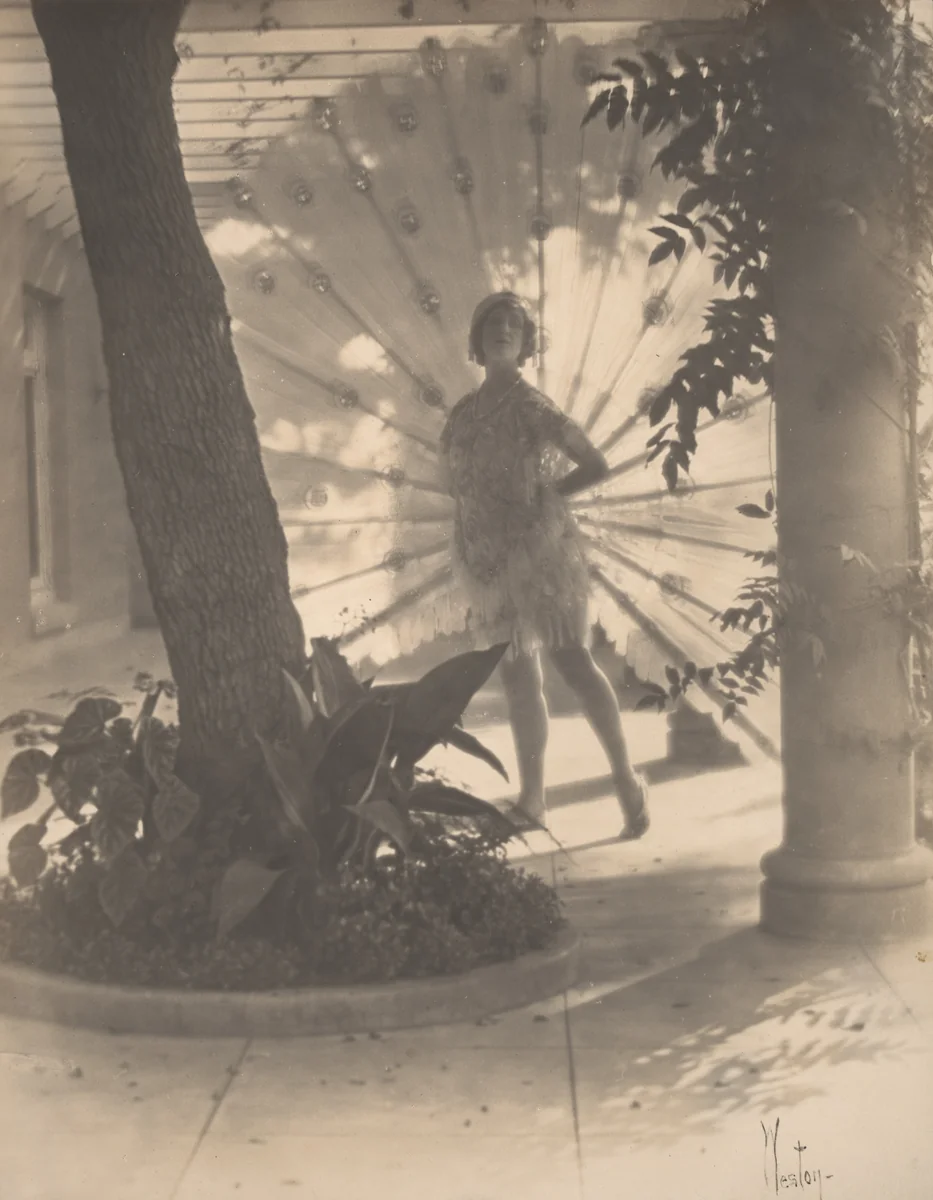 Violet Romer. (standing between tree and column with peacock fan) by Edward Weston, photograph, 1917