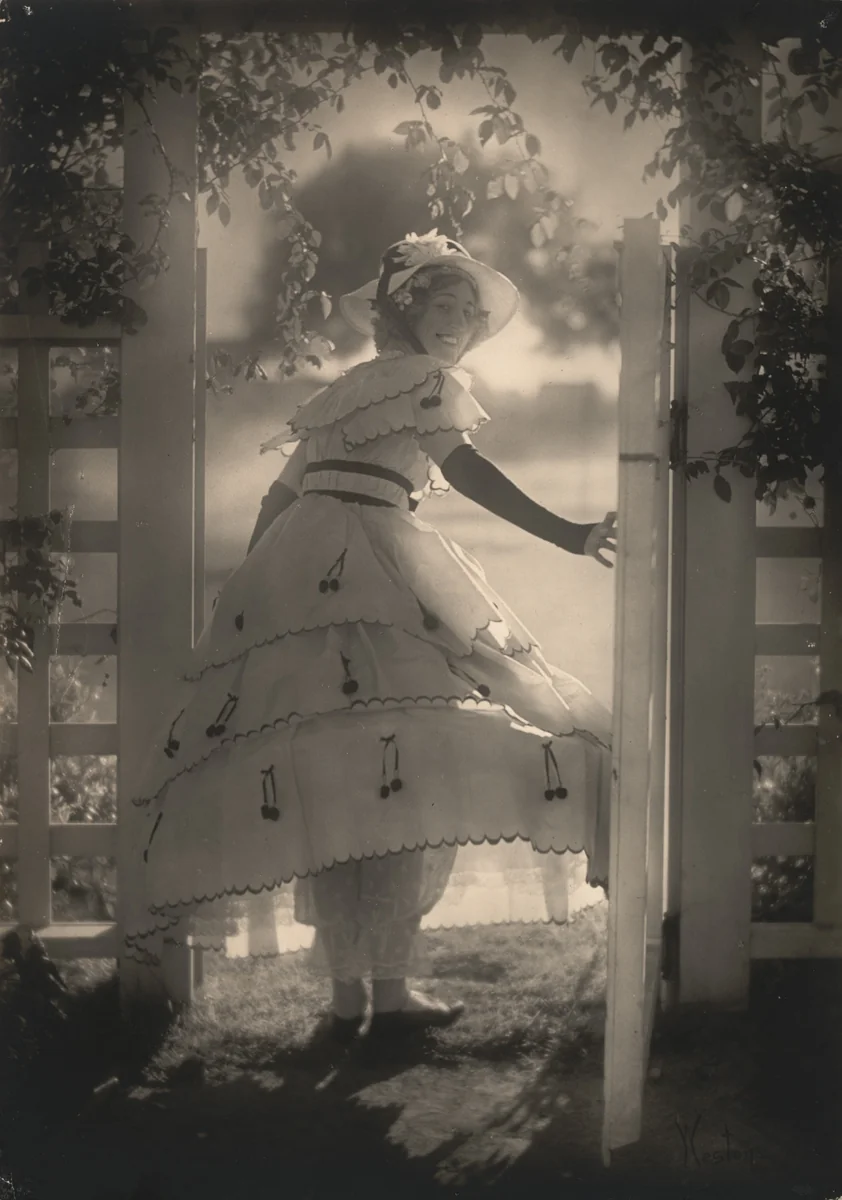Violet Romer. (in hoop skirt by white gate) by Edward Weston, photograph, 1917