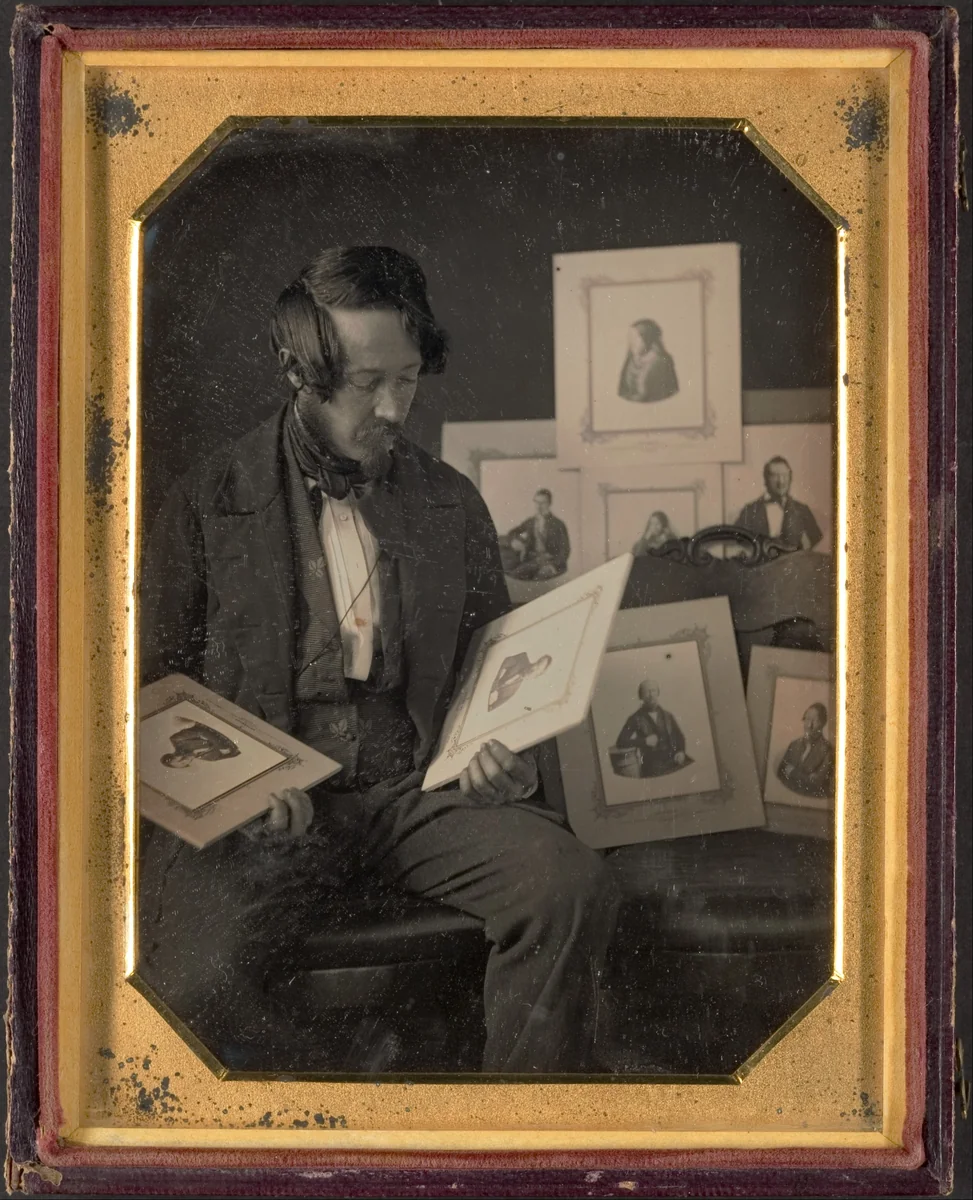 Frederick Langenheim Looking at Talbotypes by W. & F. Langenheim, photograph, 1849-1851