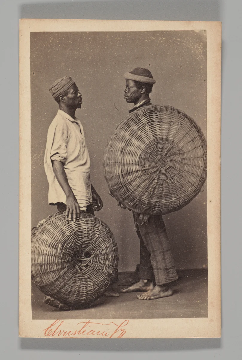 [Studio Portrait: Two Male Street Vendors in Profile with Baskets, Brazil] by Christiano Junior, photograph, 1864-1866