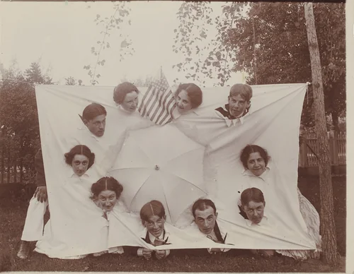 Untitled (Group sticking heads through a sheet) by American 20th Century, photograph, 1890-1919