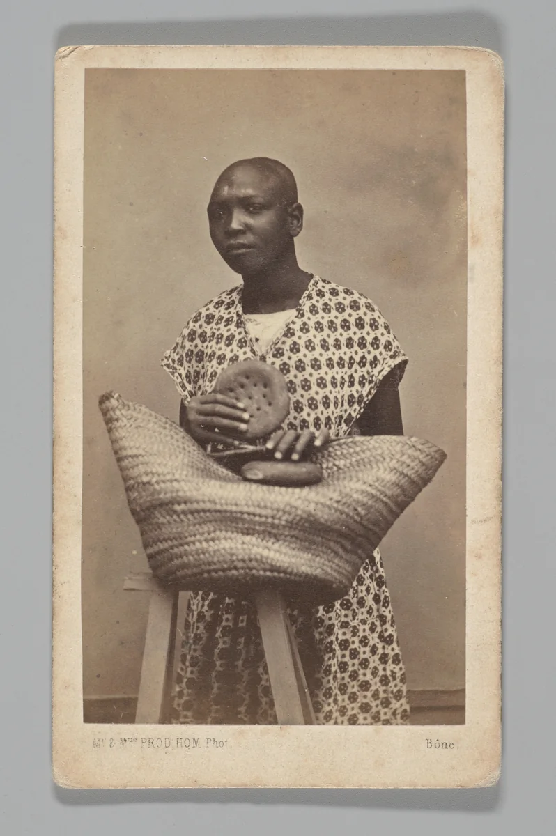 [Studio Portrait: Woman with Straw Basket, Algeria] by Maison Prod'hom, photograph, 1860-1879