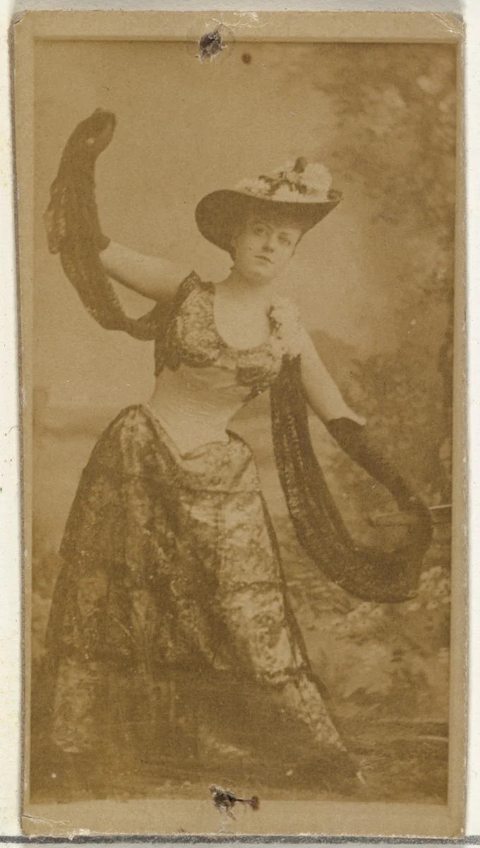 [Actress in full-length shows off ornate gown], from the Actors and Actresses series (N145-8) issued by Duke Sons & Co. to promote Duke Cigarettes by W. Duke, Sons & Co., photograph, 1890-1895