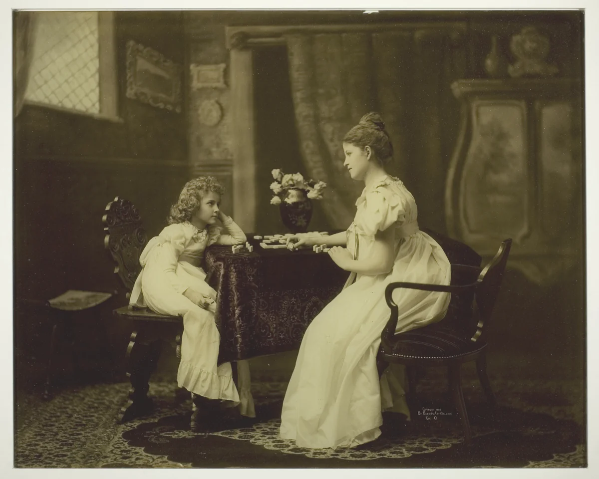 Woman and Child Playing Dominoes at Table by Artist Unknown, photograph, 1893-1903
