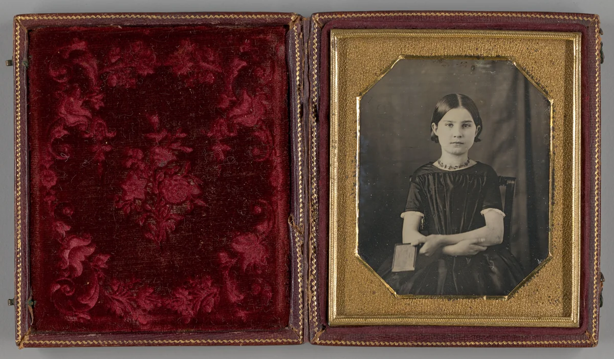 Untitled (Young Girl Holding Photograph) by Artist Unknown, photograph, 1839-1899