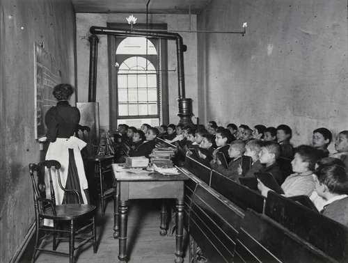 East Side Public School. A Class in the Condemned Essex Market School. Gas burning by day by Jacob August Riis, photograph, 1888