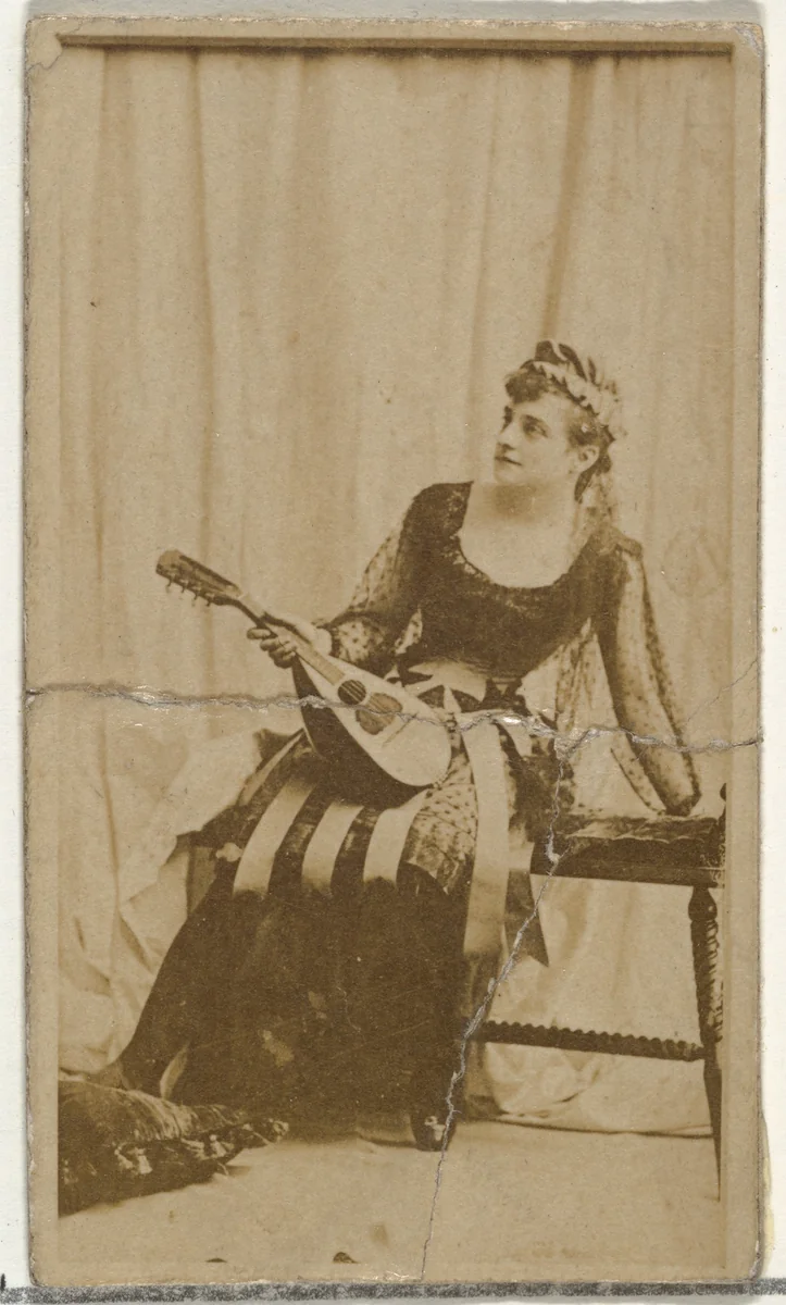 [Actress holding mandolin], from the Actors and Actresses series (N145-8) issued by Duke Sons & Co. to promote Duke Cigarettes by W. Duke, Sons & Co., photograph, 1890-1895