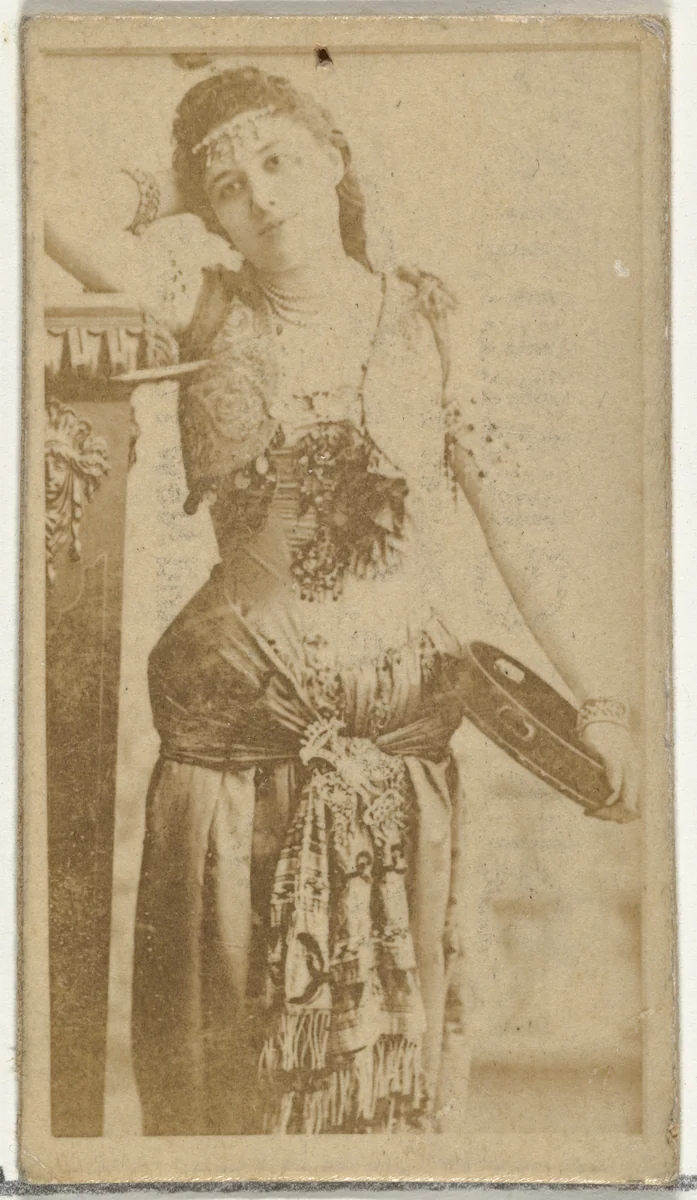 [Child holding tambourine], from the Actors and Actresses series (N145-8) issued by Duke Sons & Co. to promote Duke Cigarettes by W. Duke, Sons & Co., photograph, 1890-1895
