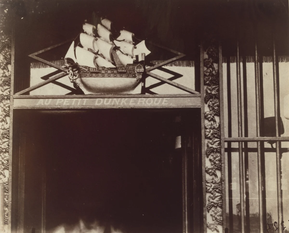 Au Petit Dunkerque. Quai conti 3 (enseigne) by Eugène Atget, photograph, 1900