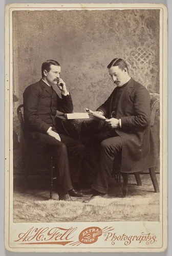 Untitled (seated portrait of two men, one with a book, the other reading a magazine) by A.H. Fell, photograph, 1880-1899