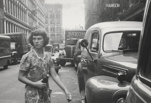 At 3:30 Connie goes across the street to Benny's to get some coffee for her boss. by Robert Frank, photograph, 1951
