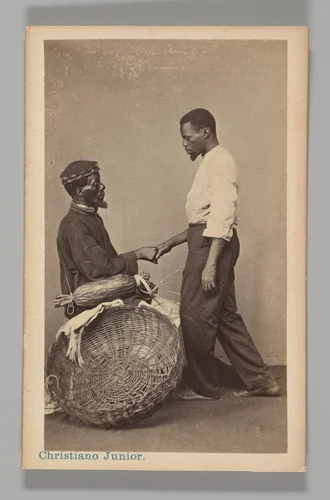 [Studio Portrait: Two Male Street Vendors in Profile, one Seated one Standing, Shaking Hands, Brazil] by Christiano Junior, photograph, 1864-1866