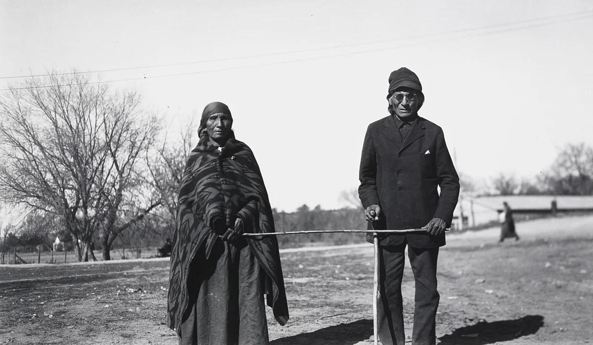 Mrs. Running Horse Leading Her Blind Husband by Eugene Buechel, photograph, 1927