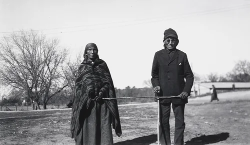 Mrs. Running Horse Leading Her Blind Husband by Eugene Buechel, photograph, 1927