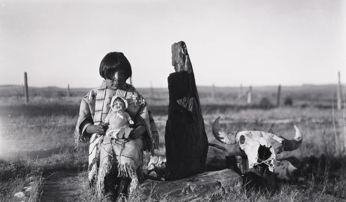 Marie Cow Killer With Doll given by Elaine and Alice Boyle, Petrified Wood and Buffalo Skull, by Eugene Buechel, photograph, 1928