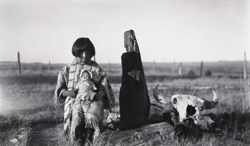Marie Cow Killer With Doll given by Elaine and Alice Boyle, Petrified Wood and Buffalo Skull, by Eugene Buechel, photograph, 1928