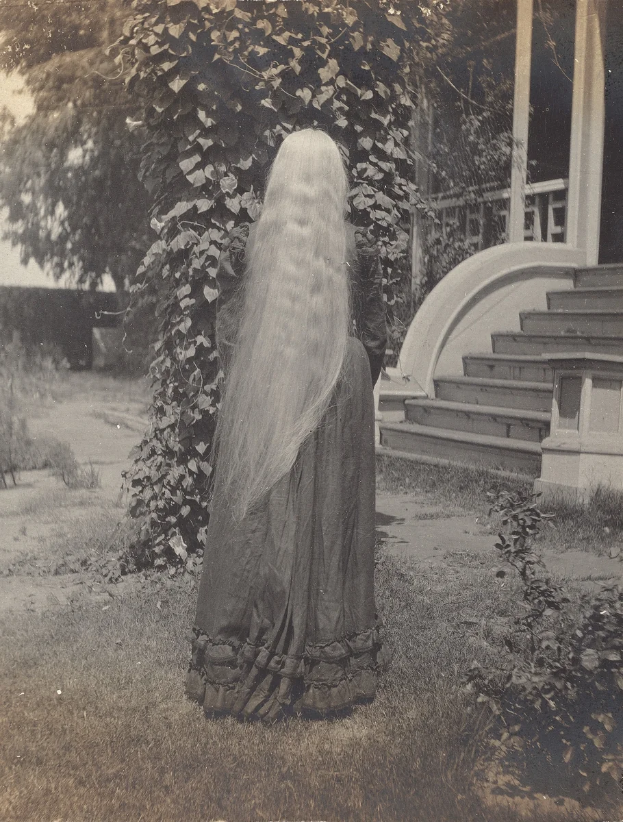 Untitled (Girl with long hair flowing down her back) by American 20th Century, photograph, 1890-1910