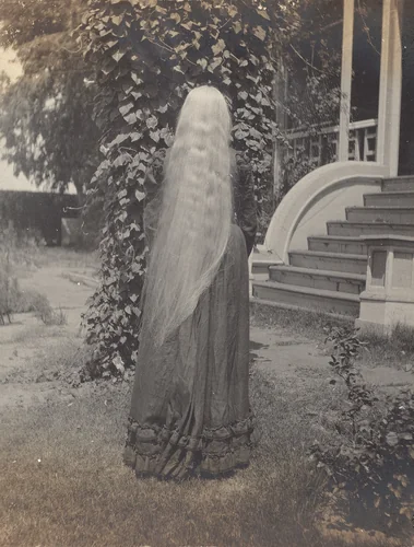 Untitled (Girl with long hair flowing down her back) by American 20th Century, photograph, 1890-1910