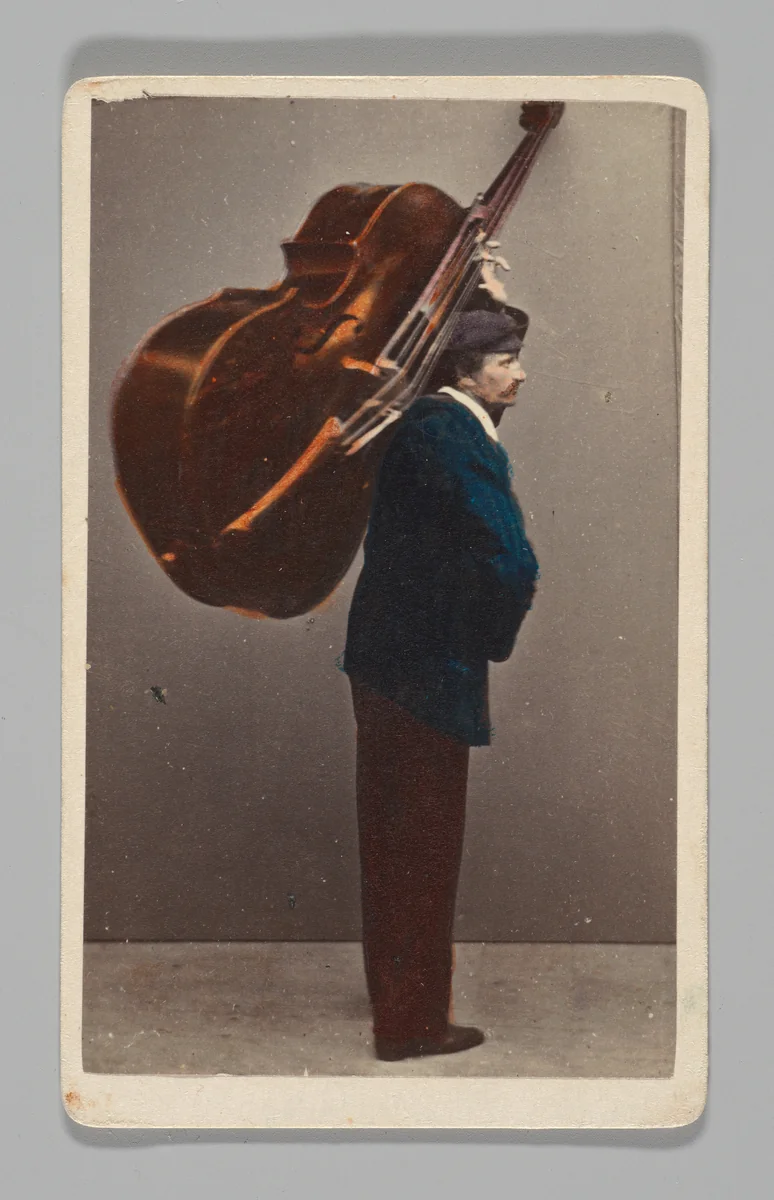 [Studio Portrait: Man Carrying Cello or Large Stringed Instrument, Venice] by Carlo Ponti, photograph, 1860-1879