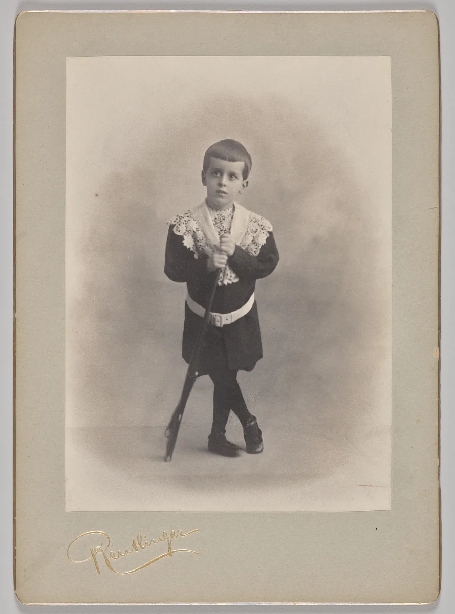 Untitled (young boy with lace collar and toy rifle) by Reutlinger Studios, photograph, 1880-1899