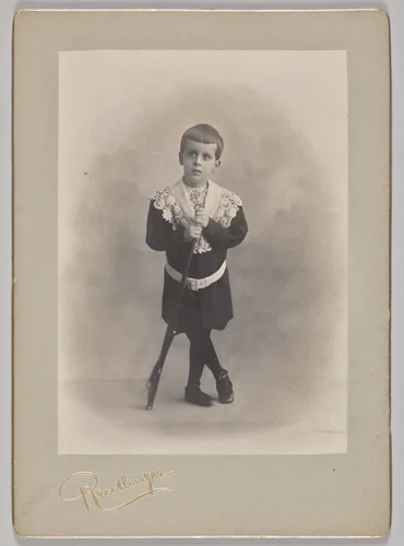 Untitled (young boy with lace collar and toy rifle) by Reutlinger Studios, photograph, 1880-1899