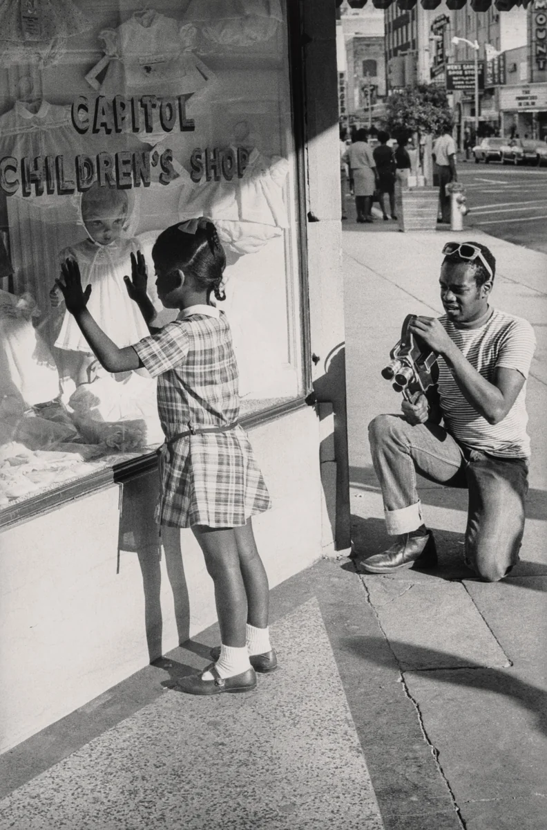 Member of Southern Media Photographing a Young Girl, Farish Street, Jackson, Mississippi by Doris A. Derby, photograph, 1968