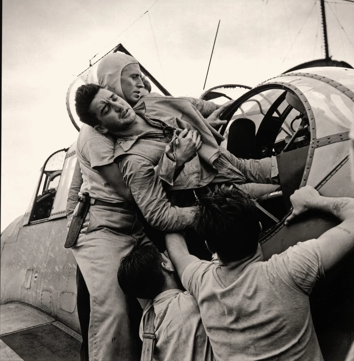 Wounded Turret Gunner Kenneth Bratton Is Lifted from His Damaged Torpedo-Bomber on Board the Saratoga by Wayne Miller, photograph, 1943
