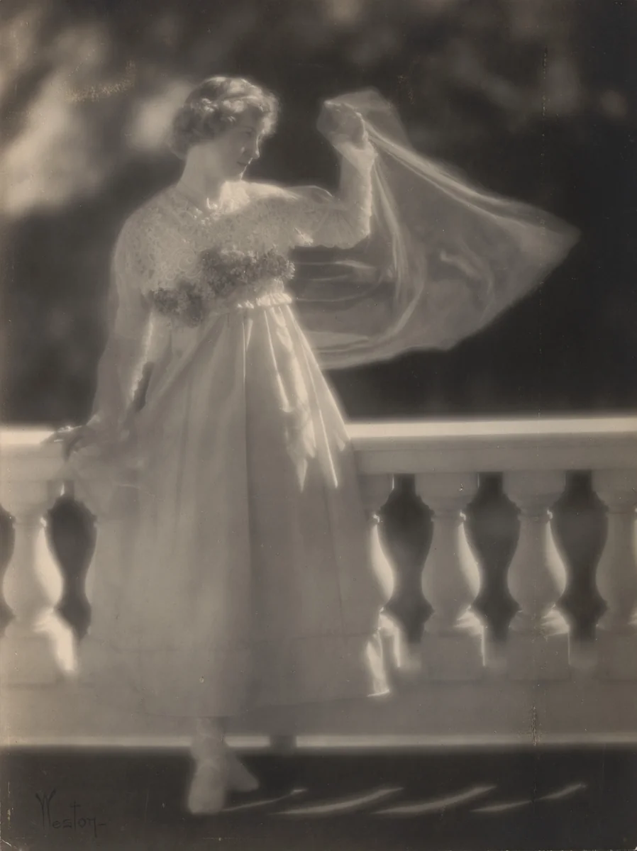 Violet Romer. (standing by balustrade with raised arm) by Edward Weston, photograph, 1917