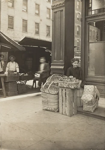 Lena Lochiavo - 11 years old, basket (and pretzel) seller, at Sixth Street Market in front of saloon entrance, Cincinnati, Ohio by Lewis Wickes Hine, photograph, 1908