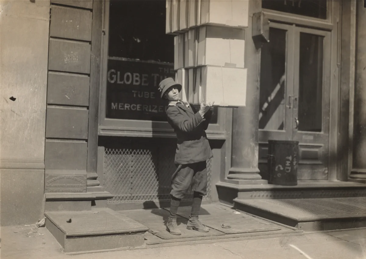 Wagon boy or "tail boy" helping to load the wagon by Lewis Wickes Hine, photograph, 1909-1919