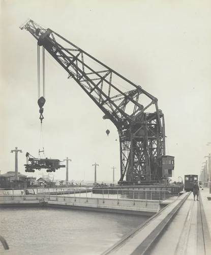 Floating crane "Hercules" transferring equipment across Gatun Locks from the east side. Steam shovel suspended in air by Unidentified Photographer, photograph, 1915