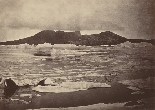 The Arctic Regions: No. 92.* The Devil's Thumb partially enveloped in a fog, with the first of the drift Ice from the pack, which was being forced towards the land, from which we escaped through a narrow lead; had we been hemmed in, we should have had to winter there by John L. Dunmore, photograph, 1869
