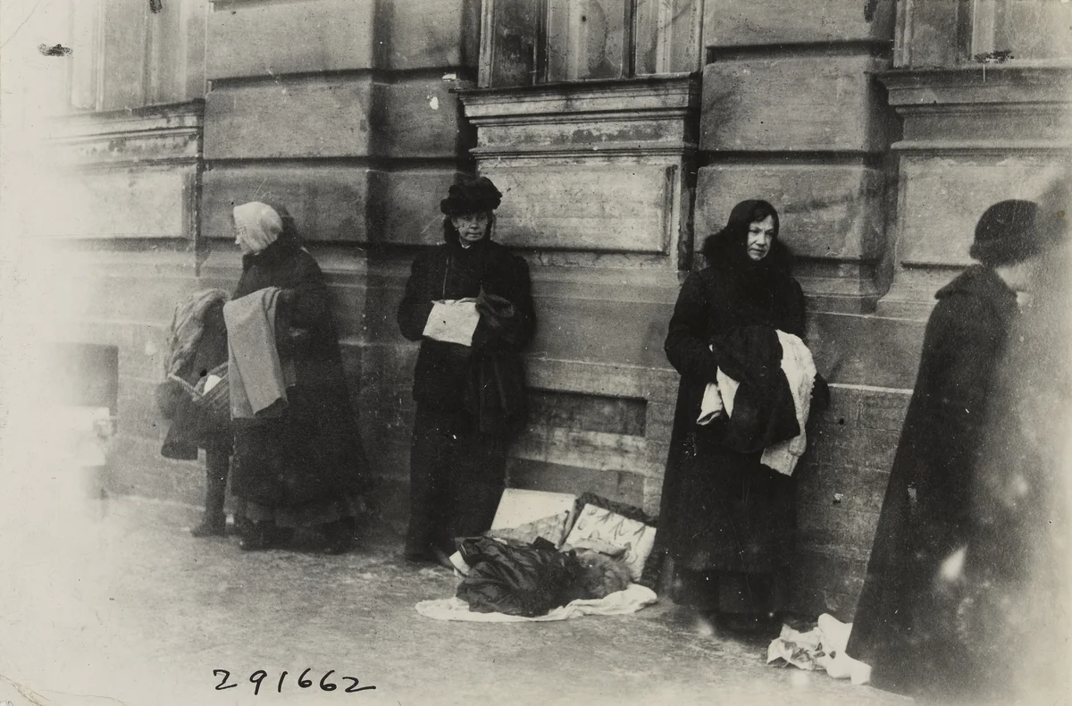 Women Selling the Remnants of Clothing Possessed by Themselves and their Family to Keep them from Starving by Underwood and Underwood, photograph, 1920