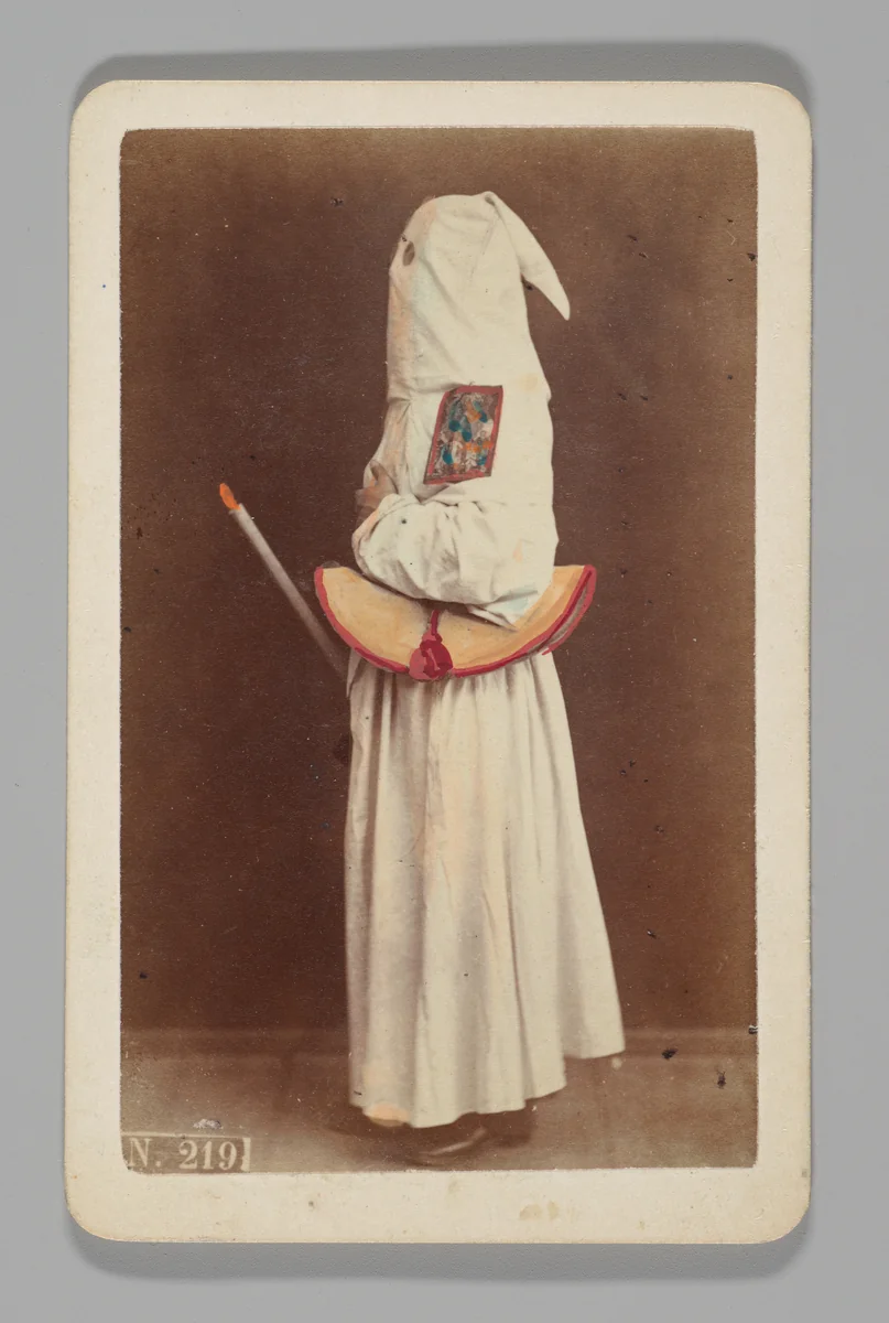 [Studio Portrait: Person Wearing White Robe and Face Covering Hood, Naples] by Giorgio Conrad, photograph, 1860-1879