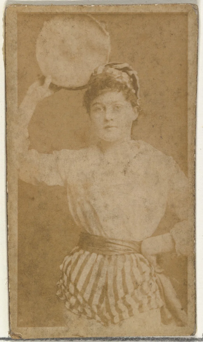 [Actress holding tambourine], from the Actors and Actresses series (N145-8) issued by Duke Sons & Co. to promote Duke Cigarettes by W. Duke, Sons & Co., photograph, 1890-1895
