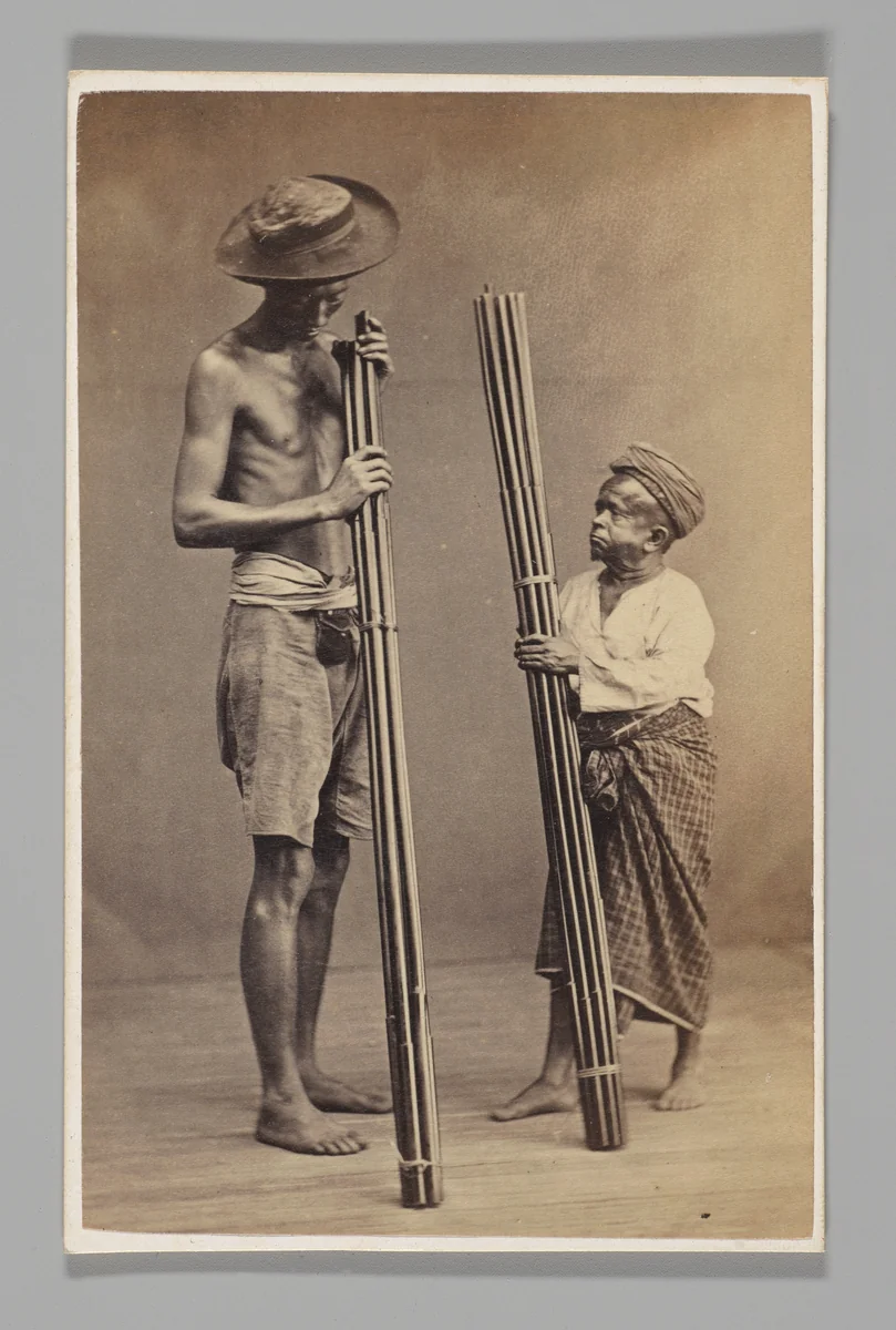 [Studio Portrait: Two Men each Holding Bamboo, Singapore] by John Thomson, photograph, 1860-1869