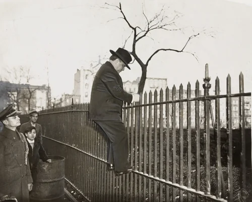 "Mayor La Guardia Climbs a Fence" by Times Wide World Photos, photograph, 1935