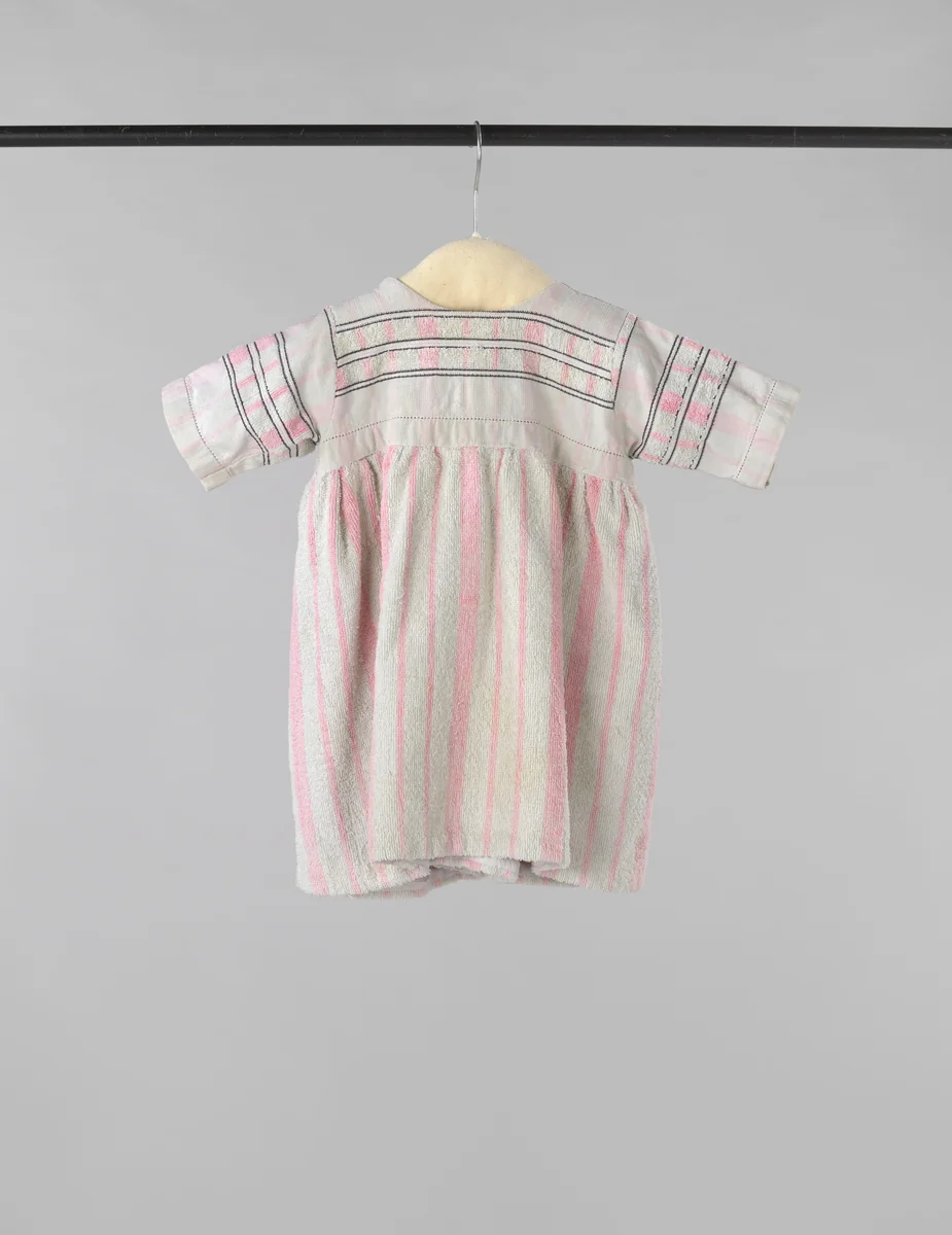 Kinderjurk met korte mouw, gemaakt van een wit-roze gestreepte badstoffen handdoek, op het lijf afgezet met zwarte siernaden by Harmina Catharina Baruch-Ponstijn, other, 1948