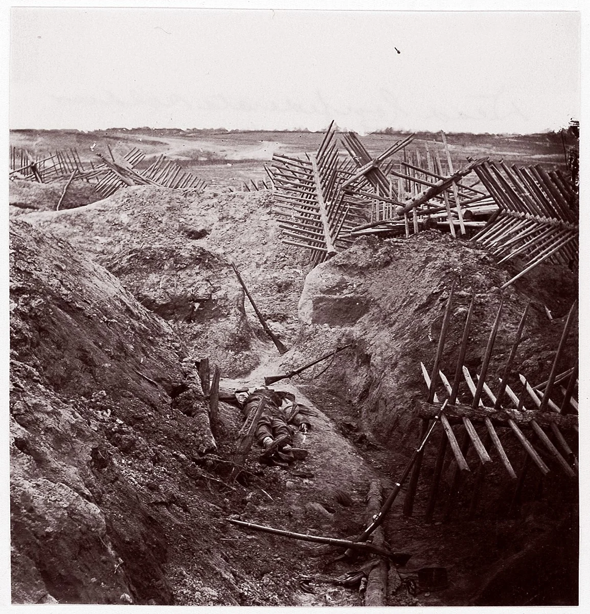 [Dead Confederate Soldier in the Trenches of Fort Mahone, Petersburg, Virginia] by Thomas C. Roche, photograph, 1865