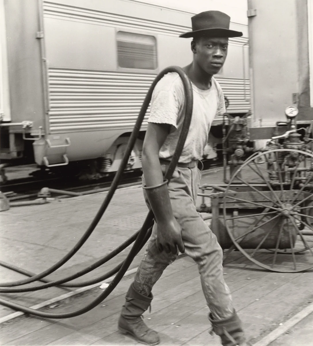 Railroad Passenger Car Maintenance Man. Air Hoses Were Used to Clean the Cars, Chicago, Illinois by Wayne Miller, photograph, 1947