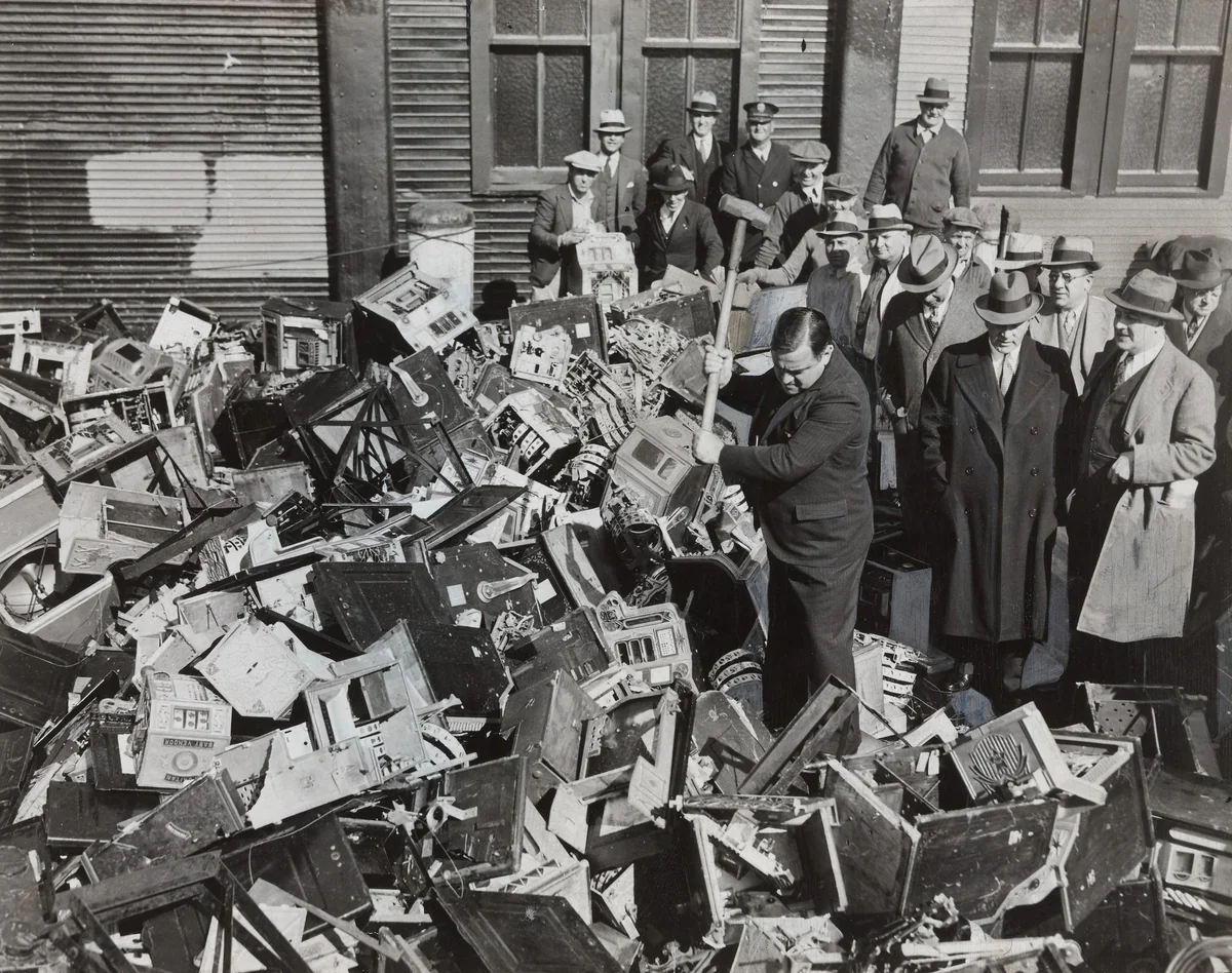Mayor La Guardia Giving the Axe to Slot Machines Which Were Dumped in Waters off Scotland Light by Times Wide World Photos, photograph, 1934