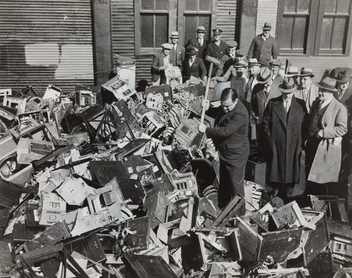 Mayor La Guardia Giving the Axe to Slot Machines Which Were Dumped in Waters off Scotland Light by Times Wide World Photos, photograph, 1934