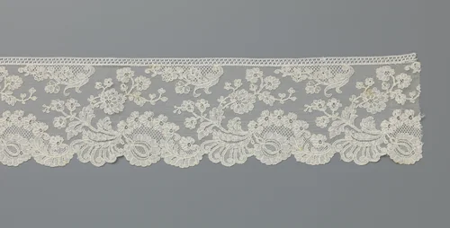 Strook machinale kant met een grote bloem onder een bloemenboogje met daaroverheen een terugbuigende bloementak by anonymous, other, 1885